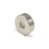 Metallic silver neodymium ring magnet with a center hole casting a soft shadow on a white background.