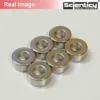 Real product photograph of six silver 11mm x 5mm x 5mm neodymium ring magnets with center holes from Scienticy.