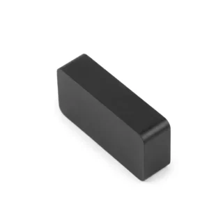A 25x11x6mm rectangular black ceramic ferrite block magnet with smooth rounded edges on a clean white background.