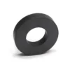 A black circular ceramic ferrite ring magnet on a white background for science experiments