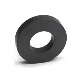 A black circular ceramic ferrite ring magnet on a white background for science experiments